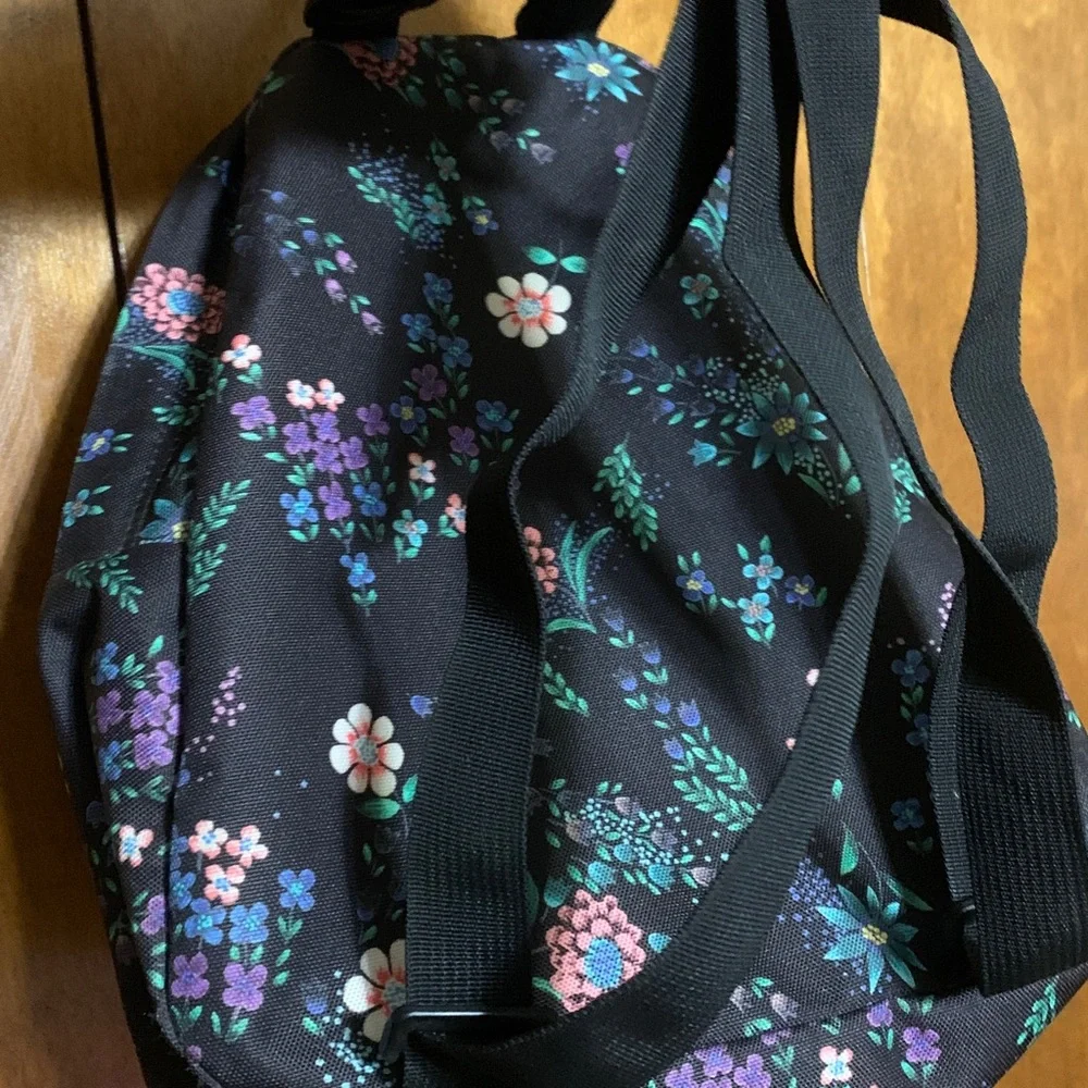 Jansport Black Mini Backpack with Pink, Purple & Green Floral Print.
